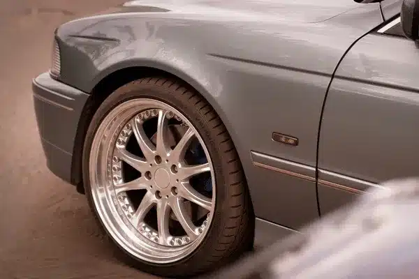 Close-up of alloy wheel and tire on parked sedan, highlighting tires waco fitment options today