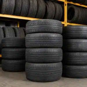 Stacks of used tires in waco are arranged neatly on racks inside a tire shop